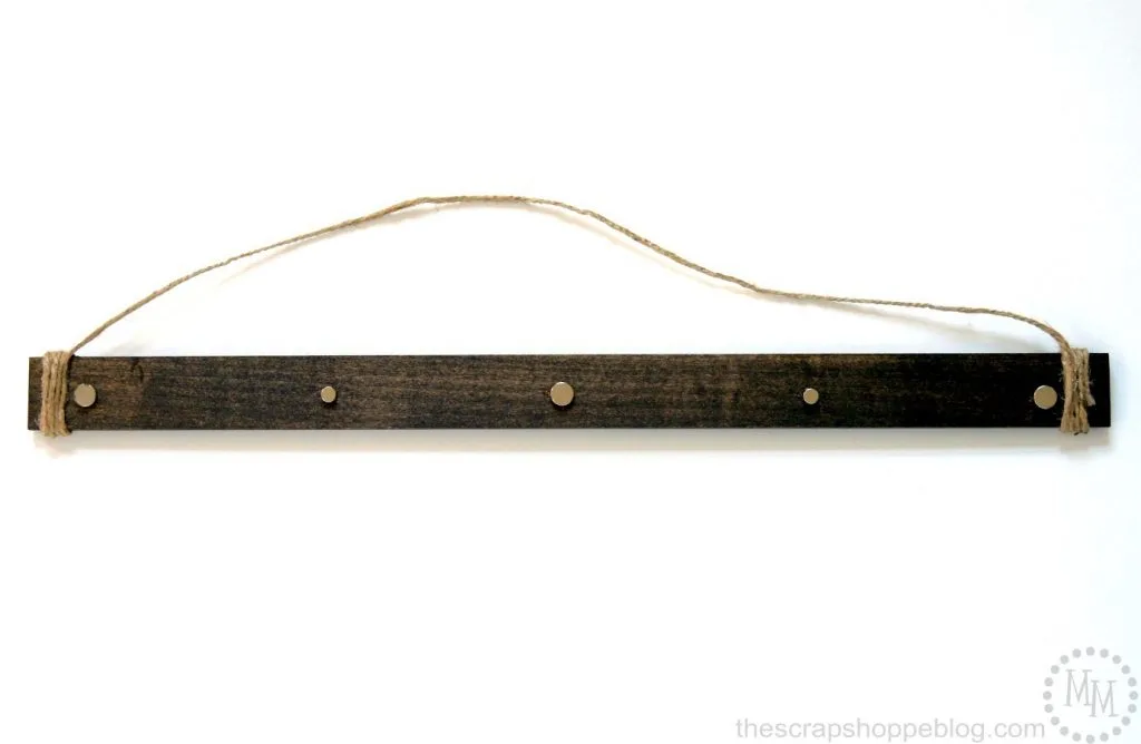 Hang fabric or paper wall decor with ease and with no holes in the material with these simple wooden wall hangers!