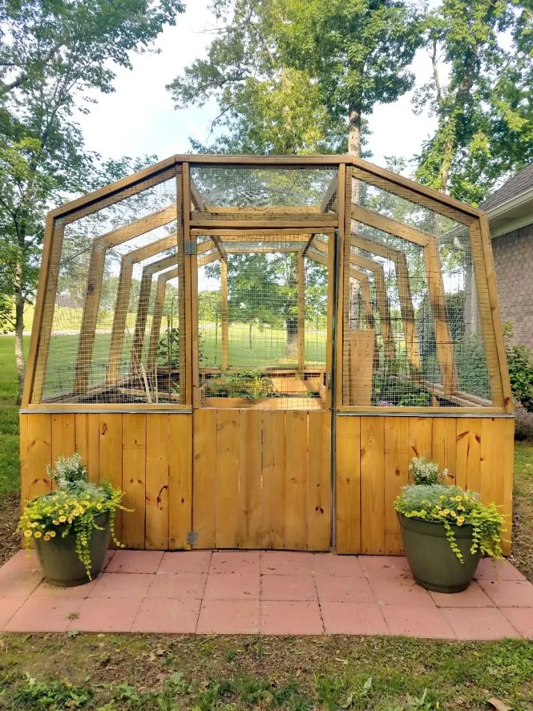 Don't let critters in your garden get you down, build a DIY enclosed garden greenhouse to keep them out!